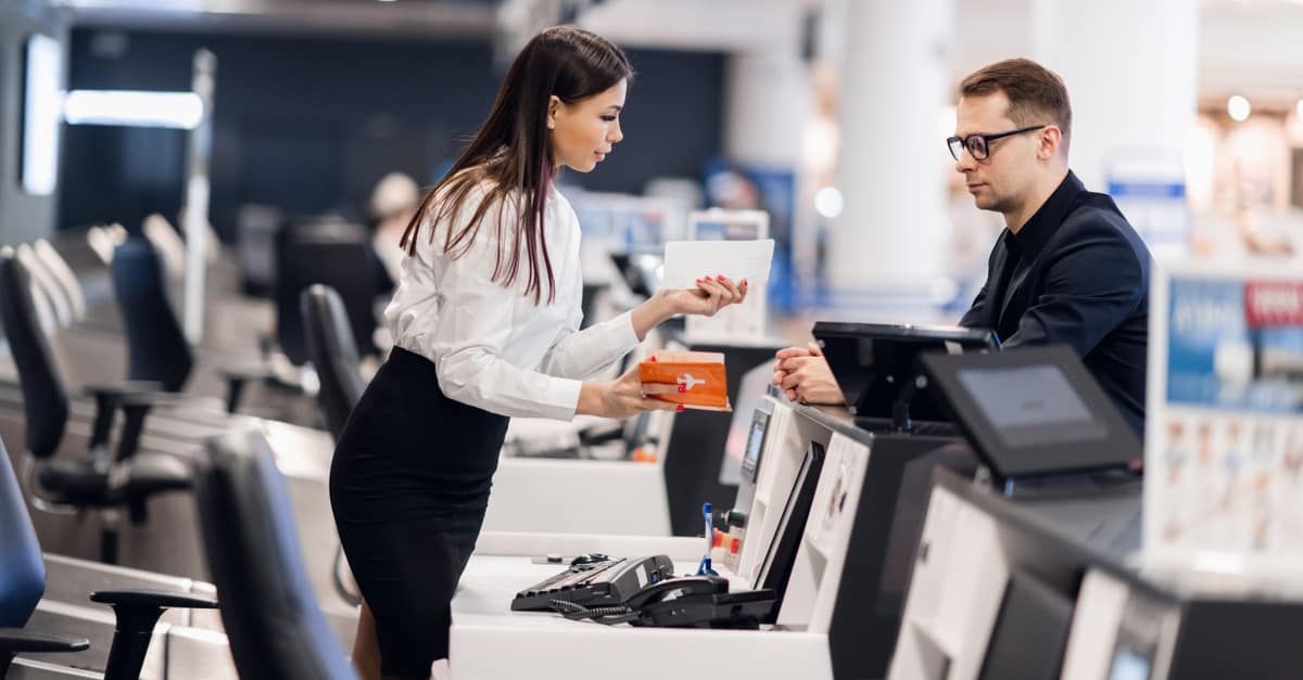 Agent qui enregistre un passager à l'aéroport